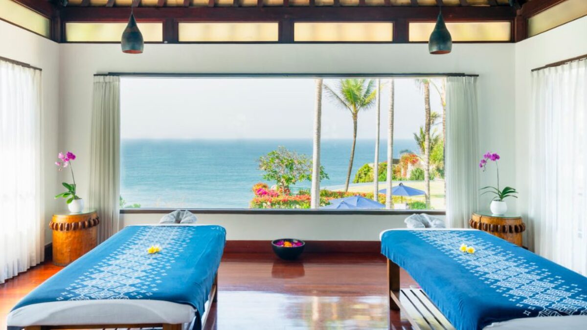 Therapist preparing a calm in-villa massage table in Kuta, Bali for post-flight jet lag recovery